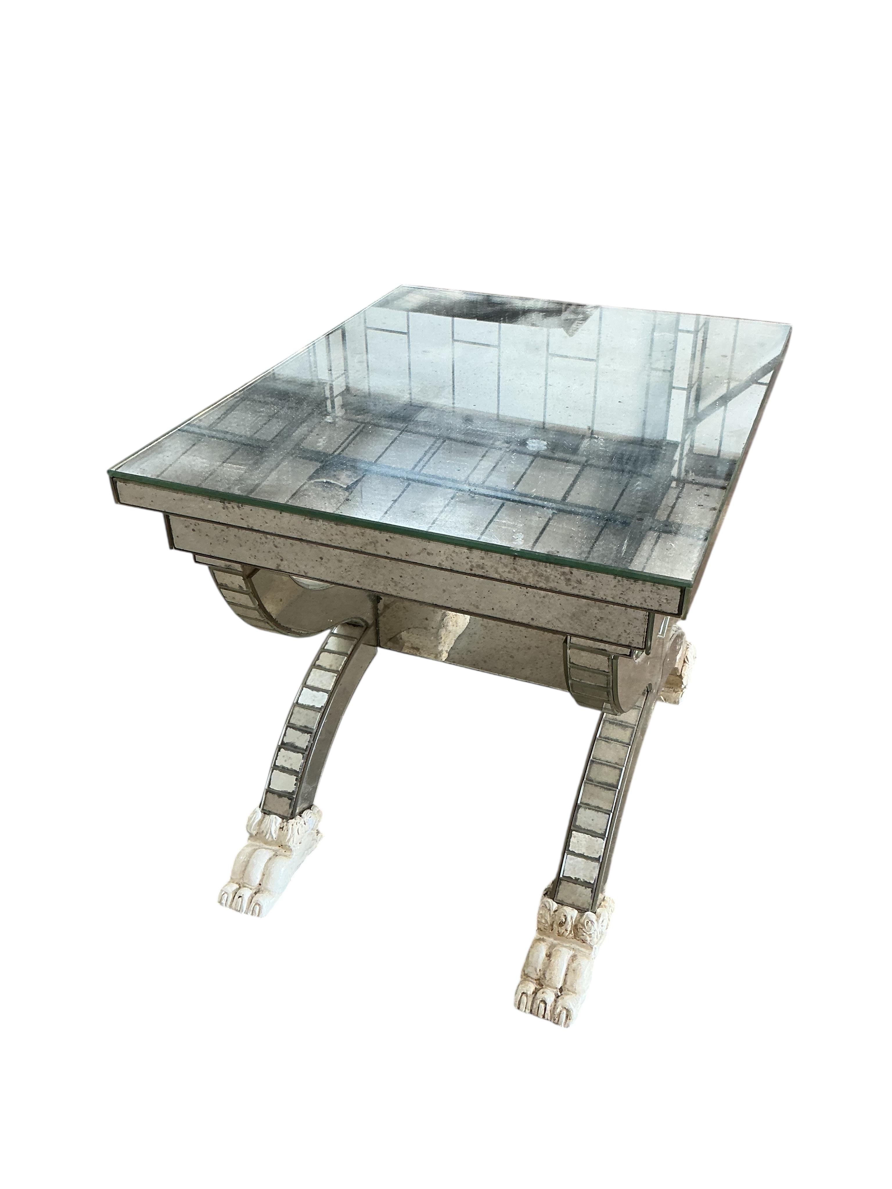 A mirror panelled X-framed lamp table, on four cream painted lion paw feet, width 56cm, depth 46cm, height 48cm